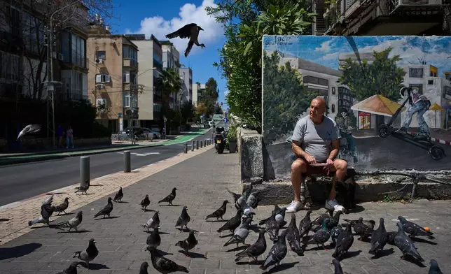 A man feeds birds on a street in Tel Aviv, Israel, after the announcement of a two-week ceasefire with Iran, Wednesday, April 8, 2026. (AP Photo/Oded Balilty)