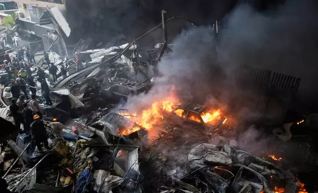First responders work at the site of an Israeli airstrike that struck an apartment building in Beirut, Lebanon, Wednesday, April 8, 2026. (AP Photo/Bilal Hussein)
