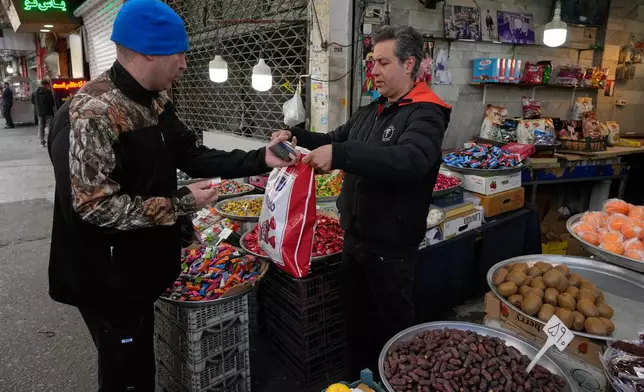 FILE - People conduct their businesses around the traditional grand bazaar of Tehran, Iran, March 29, 2026. (AP Photo/Vahid Salemi, File)