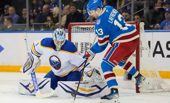 New York Rangers left wing Alexis Lafrenière (13) shoots the puck during the period of an NHL hockey game against Buffalo Sabres, Wednesday, April 8, 2026, in New York. (AP Photo/Yuki Iwamura)