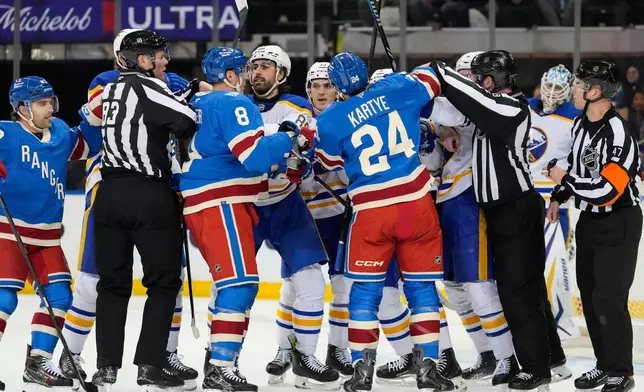 New York Rangers center J.T. Miller (8) fights with Buffalo Sabres right wing Alex Tuch (89) during the first period of an NHL hockey game, Wednesday, April 8, 2026, in New York. (AP Photo/Yuki Iwamura)