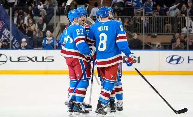 New York Rangers left wing Alexis Lafrenière (13) celebrates with teammates after scoring during the first period of an NHL hockey game against Buffalo Sabres, Wednesday, April 8, 2026, in New York. (AP Photo/Yuki Iwamura)
