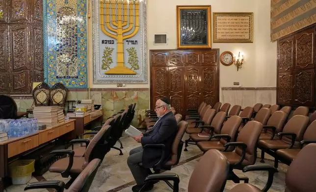 An Iranian Jewish man prays in a memorial for the slain Iranian Supreme Leader Ayatollah Ali Khamenei and other victims, who were killed in the U.S. and Israel strikes, at Yousefabad Synagogue, in Tehran, Iran, Thursday, April 16, 2026. (AP Photo/Vahid Salemi)