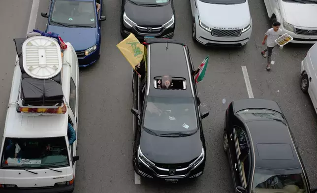 Displaced residents drive back to their villages following a ceasefire between Israel and Hezbollah, in Jiyeh, near Saida, southern Lebanon, Friday, April 17, 2026. (AP Photo/Hassan Ammar)