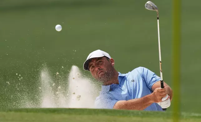 Scottie Scheffler hits from the bunker on the sixth hole during a practice round ahead of the Masters golf tournament at the Augusta National Golf Club, Tuesday, April 7, 2026, in Augusta, Ga. (AP Photo/Matt Slocum)