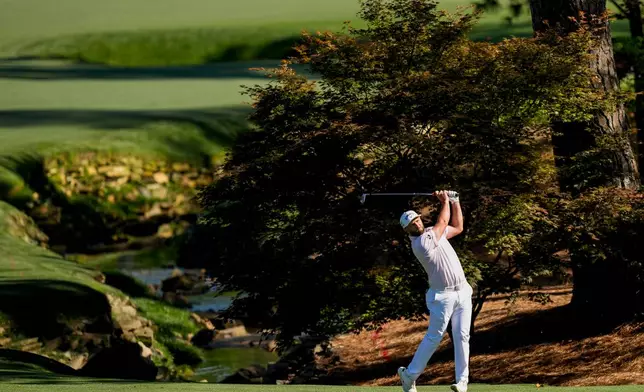 Jon Rahm, of Spain, hits from the fairway on the 13th hole during the first round of the Masters golf tournament at the Augusta National Golf Club, Thursday, April 9, 2026, in Augusta, Ga. (AP Photo/David J. Phillip)
