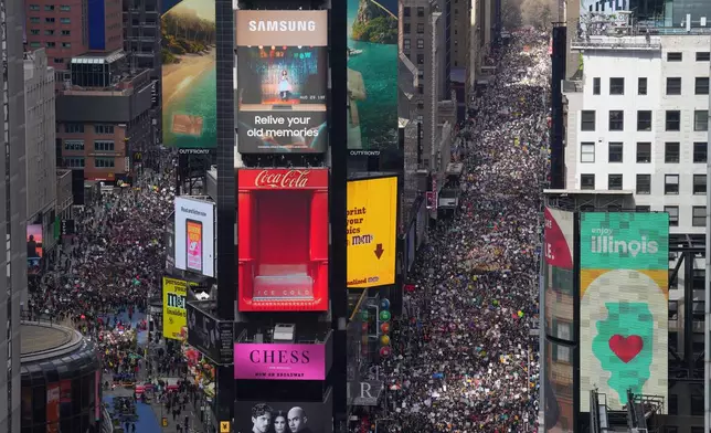 People attend a "No Kings" protest Saturday, March 28, 2026, in New York. (AP Photo/Adam Gray)