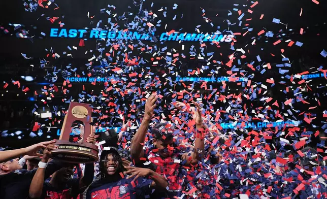 UConn players celebrate after their win against Duke in the Elite Eight of the NCAA college basketball tournament, Sunday, March 29, 2026, in Washington. (AP Photo/Abbie Parr)