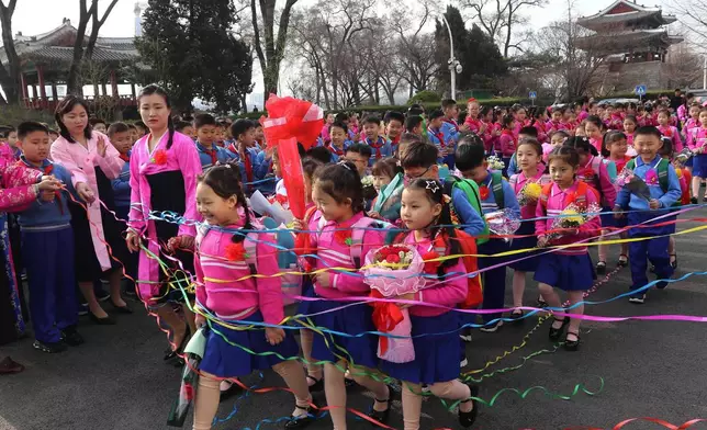 Newly enrolled pupils are welcomed by students, teachers and others during a school-opening ceremony at Kim Song Ju Primary School in Pyongyang, North Korea Wednesday, April 1, 2026. (AP Photo/Cha Song Ho)
