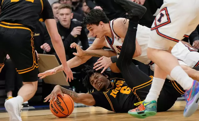 Iowa's Tavion Banks (6) and Illinois' Andrej Stojakovic battle for a loose ball during the first half of an Elite Eight game in the NCAA college basketball tournament Saturday, March 28, 2026, in Houston. (AP Photo/Ashley Landis)
