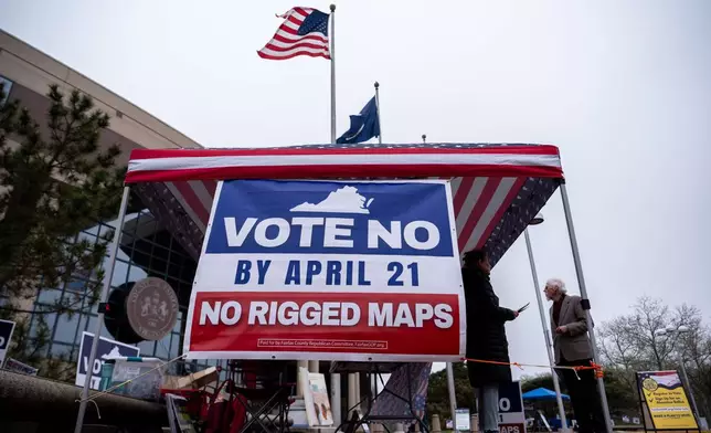 Fairfax County Republican Committee members Harry Lowcock and Esmat Mostafaeithe wait to talk voters outside the Fairfax County Government Center during early voting for the Virginia redistricting referendum Friday, April 3, 2026, in Fairfax, Va. (AP Photo/Julia Demaree Nikhinson)
