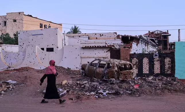 A woman walks along a street in Omdurman, Sudan, on the outskirts of Khartoum, Friday, April 17, 2026. (AP Photo/Bernat Armangue)