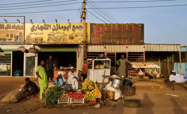 Vendors wait for customers at a local market in Sururab, near Khartoum, Sudan, Wednesday, April 22, 2026. (AP Photo/Bernat Armangue)
