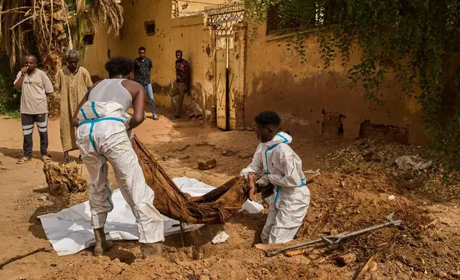 Forensic Medicine Corporation staffers exhume the body of Mohammed Alsawi, 73, who was killed in 2023 by the paramilitary group Rapid Support Forces, or RSF, in Omdurman, on the outskirts of Khartoum, Sudan, Monday, April 20, 2026. (AP Photo/Bernat Armangue)