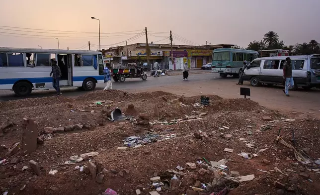Graves that have overflowed onto the sidewalk of a street in Omdurman, on the outskirts of Khartoum, Sudan, Monday, April 20, 2026. (AP Photo/Bernat Armangue)