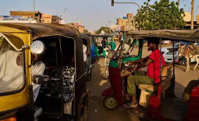 Tuk-tuk drivers cross an intersection in Omdurman, Sudan, on the outskirts of Khartoum, Tuesday, April 21, 2026. (AP Photo/Bernat Armangue)