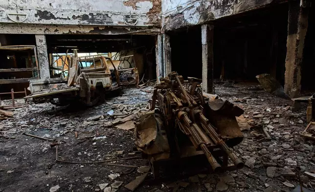 The wreckage of an armored pickup truck is pictured in the lobby of a hotel destroyed during the war in downtown Khartoum, Sudan, Sunday, April 19, 2026. (AP Photo/Bernat Armangue)