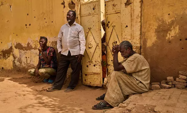 Abubakr Alsawi, right, waits during the exhumation of his brother Mohammed Alsawi, 73, who was killed in 2023 by the paramilitary group Rapid Support Forces, or RSF, in Omdurman, on the outskirts of Khartoum, Sudan, Monday, April 20, 2026. (AP Photo/Bernat Armangue)