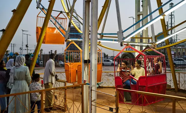 Children enjoy an amusement park in downtown Khartoum, Sudan, Sunday, April 19, 2026. (AP Photo/Bernat Armangue)
