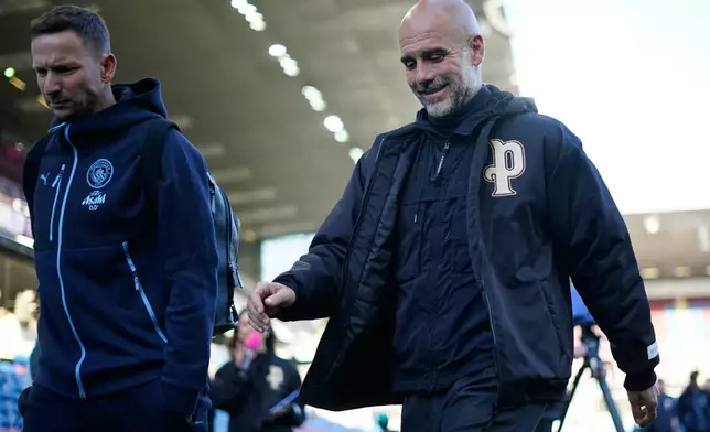 Manchester City's head coach Pep Guardiola arrives fior the Premier League soccer match between Burnley and Manchester City in Burnley, England, Wednesday, April 22, 2026. (AP Photo/Dave Thompson)