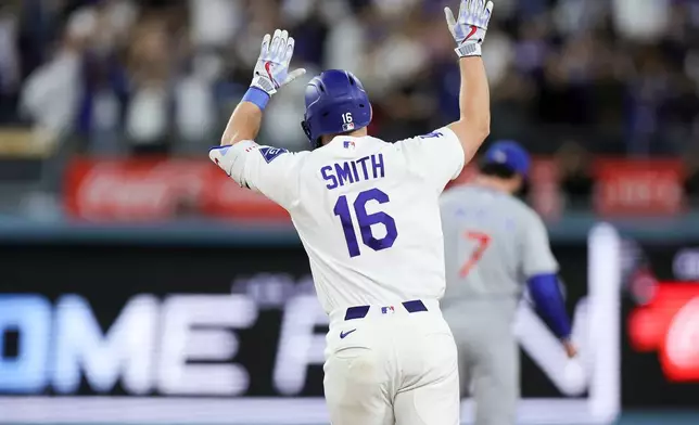 Los Angeles Dodgers' Will Smith runs the bases after hitting a three-run home run during the third inning of a baseball game against the Chicago Cubs, Friday, April 24, 2026, in Los Angeles. (AP Photo/Ryan Sun)