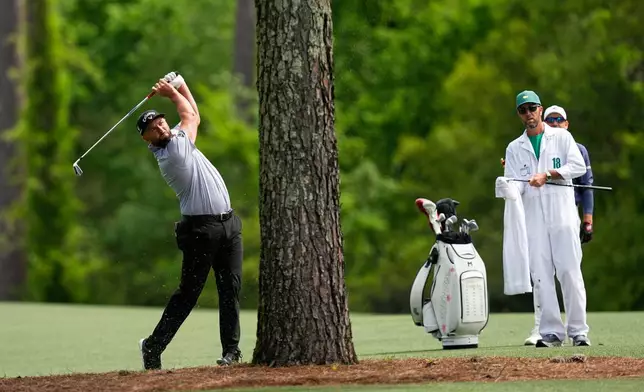 Jon Rahm, of Spain, hits from the fairway on the 11th hole during a practice round ahead of the Masters golf tournament at the Augusta National Golf Club, Tuesday, April 7, 2026, in Augusta, Ga. (AP Photo/David J. Phillip)