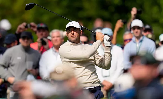 Scottie Scheffler watches his tee shot on the 17th hole during a practice round ahead of the Masters golf tournament at the Augusta National Golf Club, Wednesday, April 8, 2026, in Augusta, Ga. (AP Photo/Eric Gay)