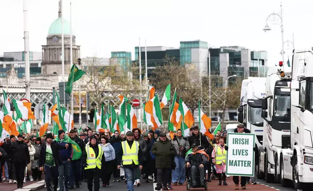 Protesters make their way to O'Connell Street during the fifth day of a National Fuel Protest, in Dublin, Ireland, Saturday, April 11, 2026. (AP Photo/Peter Morrison)