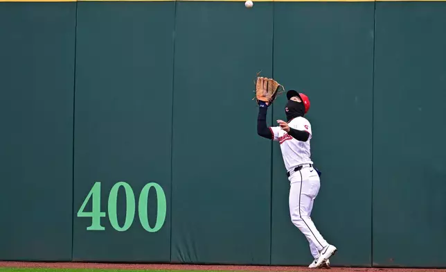 Cleveland Guardians center fielder Steven Kwan catches a ball hit by Chicago Cubs center fielder Pete Crow-Armstrong during the fourth inning of a baseball game, Sunday, April 5, 2026, in Cleveland. (AP Photo/David Dermer)