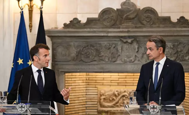 Greece's Prime Minister Kyriakos Mitsotakis, right, and France's President Emmanuel Macron participate in a media conference at Maximos Mansion in Athens, Greece, Saturday, April 25, 2026. (AP Photo/Michael Varaklas)