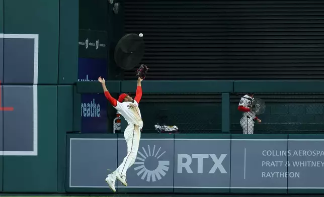 Washington Nationals right fielder James Wood attempts to catch a double hit by Atlanta Braves' Jonah Heim during the seventh inning of a baseball game, Tuesday, April 21, 2026, in Washington. (AP Photo/Terrance Williams)