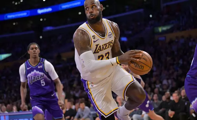 Los Angeles Lakers forward LeBron James looks to make a pass during the first half of an NBA basketball game against the Utah Jazz, Sunday, April 12, 2026, in Los Angeles. (AP Photo/Jayne Kamin-Oncea)