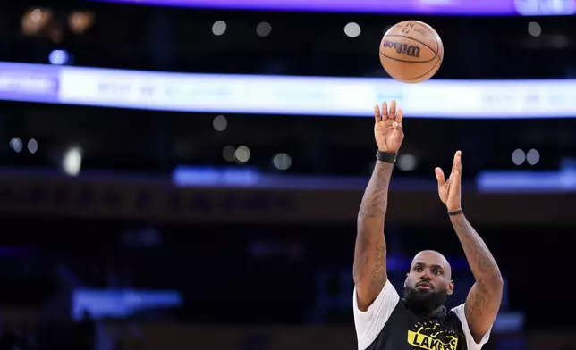 Los Angeles Lakers forward LeBron James warms up before an NBA basketball game against the Phoenix Suns, Friday, April 10, 2026, in Los Angeles. (AP Photo/Jessie Alcheh)