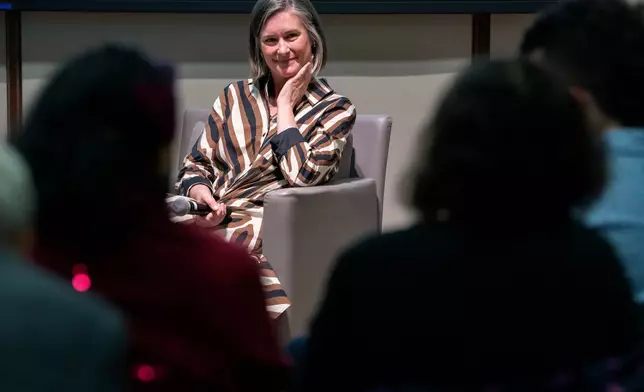 Katharine Wilkinson gives a talk about living with climate uncertainty at American University in Washington on April 14, 2026. (AP Photo/Michael Phillis)