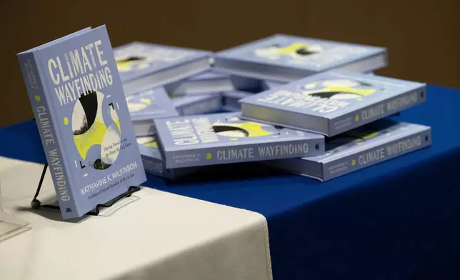 Katharine Wilkinson's book "Climate Wayfinding: Healing Ourselves and the Planet We Call Home" is displayed at her talk on April 14, 2026, in Washington. (AP Photo/Michael Phillis)