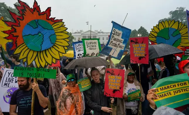 FILE - Climate activists hold a rally to protest the use of fossil fuels on Earth Day in the rain front of the White House on April 22, 2023, in Washington. (AP Photo/Carolyn Kaster, File)