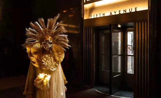 Henrieta Scholtzova stands inside Rockefeller Center during the Easter Bonnet Parade on Fifth Avenue, Sunday, April 5, 2026, in New York. (AP Photo/Adam Gray)
