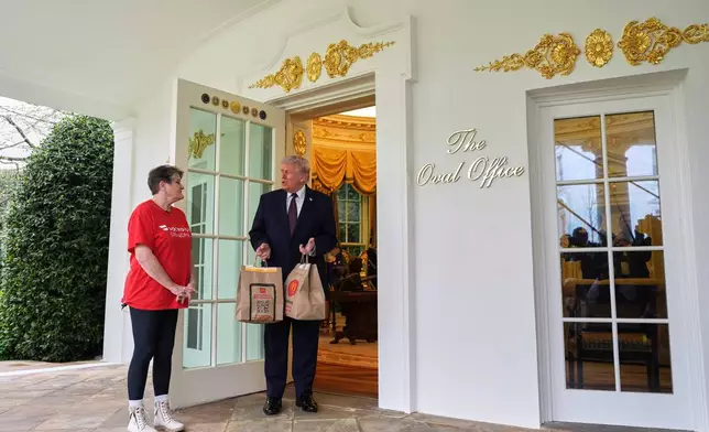 ADDS NAME SHARON SIMMONS - President Donald Trump speaks to Sharon Simmons, a Dasher from Arkansas, who delivered him two bags of McDonald's food outside the Oval Office of the White House, Monday, April 13, 2026, in Washington. (AP Photo/Alex Brandon)