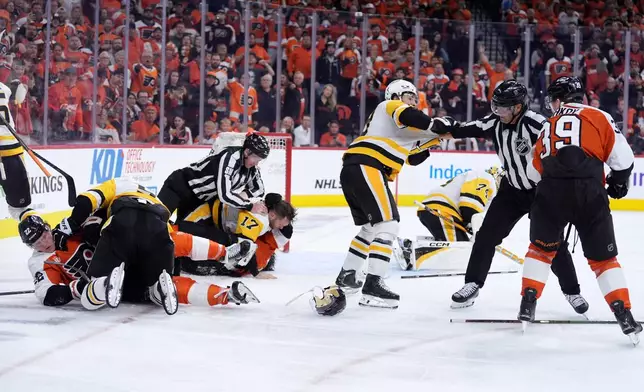 Philadelphia Flyers and Pittsburgh Penguins players fight during the second period of Game 3 in the first round of the NHL Stanley Cup hockey playoffs Wednesday, April 22, 2026, in Philadelphia. (AP Photo/Matt Slocum)