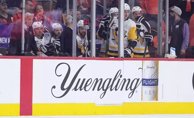 Pittsburgh Penguins' players watch from the penalty box during the second period of Game 3 against the Philadelphia Flyers in the first round of the NHL Stanley Cup hockey playoffs Wednesday, April 22, 2026, in Philadelphia. (AP Photo/Matt Slocum)