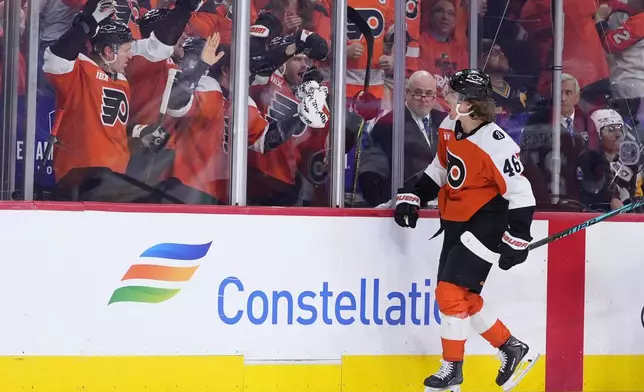 Philadelphia Flyers' Trevor Zegras, right, celebrates with teammates in the penalty box after scoring a goal during the second period of Game 3 against the Pittsburgh Penguins in the first round of the NHL Stanley Cup hockey playoffs Wednesday, April 22, 2026, in Philadelphia. (AP Photo/Matt Slocum)