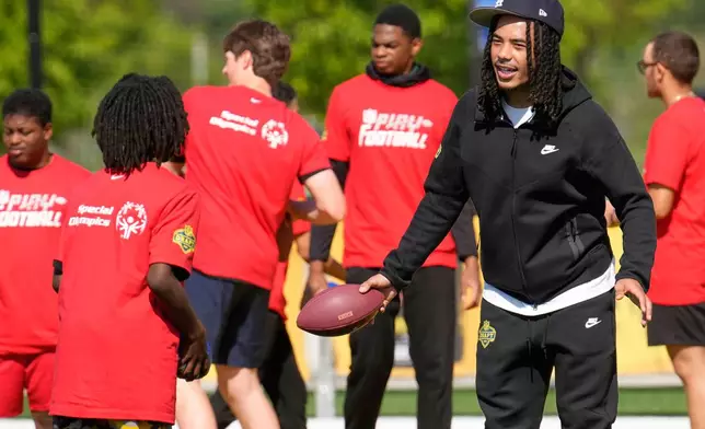 Makai Lemon, USC wide receiver, works with local youth football players and Special Olympics athletes during the league's annual prospect clinic ahead of the NFL football draft Wednesday,April 22, 2026, in Pittsburgh. (AP Photo/Sue Ogrocki)