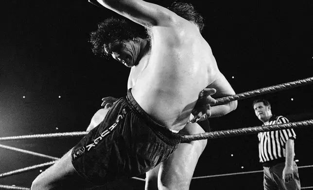 FILE - Chuck Wepner is tossed out of the Shea Stadium ring by Andre the Giant, June 25, 1976, in New York. (AP Photo/Ray Stubblebine, File)