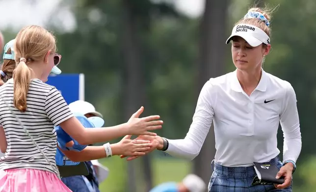 Nelly Korda greets fans on the way to the eighth hole during the third round of the Chevron Championship LPGA golf tournament Saturday, April 25, 2026, in Houston. (AP Photo/Ashley Landis)