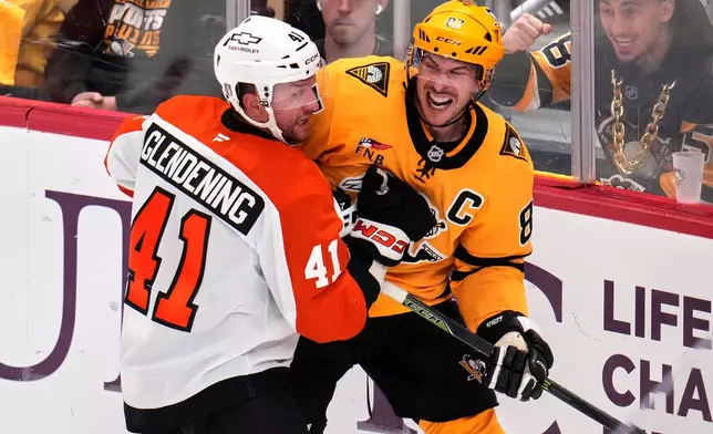 Pittsburgh Penguins' Sidney Crosby, right, is defended by Philadelphia Flyers' Luke Glendening (41) during the third period of Game 5 in the first round of an NHL hockey Stanley Cup playoff series in Pittsburgh, Monday, April 27, 2026. (AP Photo/Gene J. Puskar)