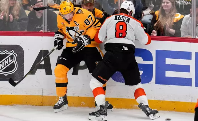 Pittsburgh Penguins' Sidney Crosby (87) is checked off the puck by Philadelphia Flyers' Cam York (8) during the third period of Game 5 in the first round of an NHL hockey Stanley Cup playoff series in Pittsburgh, Monday, April 27, 2026. (AP Photo/Gene J. Puskar)