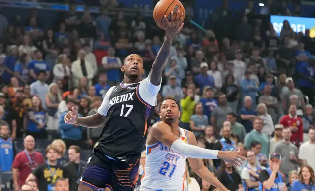 Phoenix Suns guard Jamaree Bouyea (17) looks to shoot in front of Oklahoma City Thunder guard Aaron Wiggins (21) during the first half of an NBA basketball game, Sunday, April 12, 2026, in Oklahoma City. (AP Photo/Kyle Phillips)