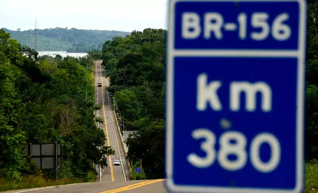 Vehicles drive on a fully paved section of BR-156 highway that connects the state capital Macapa with the city of Oiapoque, Amapa state, Brazil, Monday, March 9, 2026. (AP Photo/Eraldo Peres)