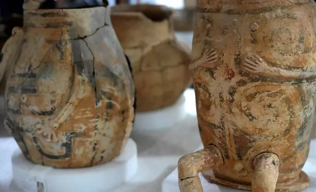 Pottery vessels with anthropomorphic features believed to be urns are displayed at the Institute for Scientific and Technological Research in Macapa, Amapa state, Brazil, Sunday, March 8, 2026. (AP Photo/Eraldo Peres)