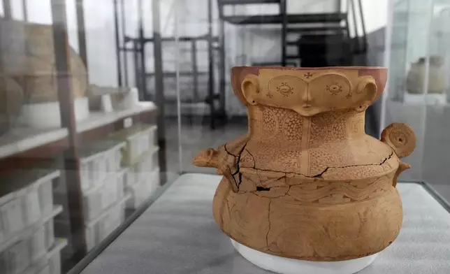 A pottery vessel with anthropomorphic features believed to be an urn is displayed at the Institute for Scientific and Technological Research in Macapa, Amapa state, Brazil, Sunday, March 8, 2026. (AP Photo/Eraldo Peres)